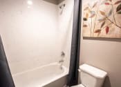Thumbnail 8 of 26 - bathtub and toilet