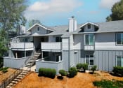 Thumbnail 3 of 17 - a large gray house with a gray roof