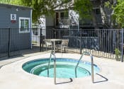 Thumbnail 6 of 17 - a hot tub with a table and chairs next to it