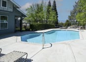 Thumbnail 5 of 17 - a pool with a fence around it and a house in the background