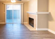 Thumbnail 9 of 17 - a living room with a fireplace and a window