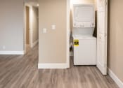 Thumbnail 11 of 17 - a laundry room with a washer and dryer and a door to a hallway