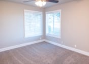 Thumbnail 14 of 17 - an empty room with two windows and a ceiling fan