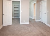 Thumbnail 16 of 17 - an empty room with a carpeted floor and a closet