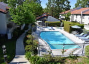 Thumbnail 2 of 25 - View of pools from 2nd floor featuring lounge chairs, seating area, and spa.