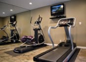 Thumbnail 6 of 25 - View of gym with treadmill, elliptical, and TV