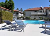 Thumbnail 3 of 25 - View of pool, lounge chairs, and exterior of buildings