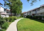 Thumbnail 9 of 25 - View of exterior building with sidewalk and green shrubbery Wide walking paths and large lawns