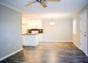 Thumbnail 20 of 25 - View of living space with wood look flooring, partial view of kitchen