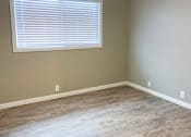 Thumbnail 3 of 12 - living area with wood look flooring, well lit window, and ceiling fan