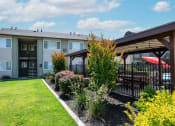Thumbnail 11 of 34 - View of courtyard area with exterior of building with lush landscaping next to gated community pool