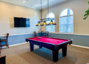 Thumbnail 19 of 19 - a game room with a pink pool table and a tv