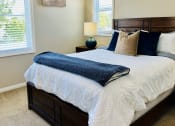 Thumbnail 8 of 19 - a bedroom with a bed and two windows