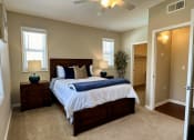 Thumbnail 7 of 19 - a bedroom with a large bed and a ceiling fan