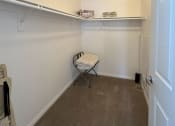 Thumbnail 9 of 19 - a room with a chair and a shelf on the wall