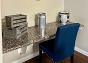 Thumbnail 4 of 19 - a desk with a blue chair and a clock on the wall