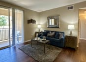 Thumbnail 1 of 19 - a living room with a blue couch and a coffee table