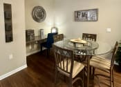 Thumbnail 3 of 19 - a dining room with a glass table and a ceiling fan