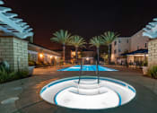 Thumbnail 14 of 19 - a pool with ahot tub at night at Vista Pointe