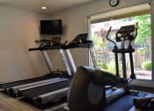 Thumbnail 22 of 23 - a gym with cardio equipment