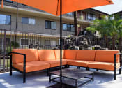 Thumbnail 21 of 23 - a patio with orange couches