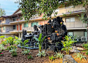 Thumbnail 25 of 28 - a building with a rock sculpture in the front of it