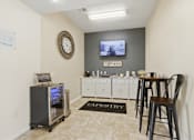 Thumbnail 5 of 65 - A room with a bar and a TV on the wall.