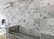 Thumbnail 48 of 76 - A bathroom with a tiled wall and a shower.