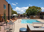 Thumbnail 2 of 14 - Resort style pool with lounge chairs and spa at Pinon Lofts Apartments, Sedona, Arizona