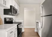 Thumbnail 2 of 48 - a kitchen with white cabinets and black appliances at Denim Scottsdale, Scottsdale, AZ, 85251