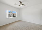Thumbnail 13 of 65 - Empty room with a ceiling fan and a window.