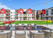 Thumbnail 64 of 76 - A row of red and white buildings with a lawn in front.