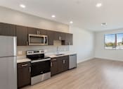 Thumbnail 2 of 22 - A modern kitchen with wooden cabinets and stainless steel appliances.at The 89 on Hayden, Arizona  