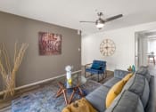 Thumbnail 19 of 36 - a living room with a couch and a clock on the wall  at Glen Brae, Glendale, AZ, 85301