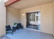 Thumbnail 31 of 36 - a patio with chairs and a sliding glass door  at Glen Brae, Glendale, AZ, 85301