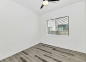 Thumbnail 41 of 81 - A room with a ceiling fan and a window with blinds at Marketside Villas at Verrado, Buckeye, AZ