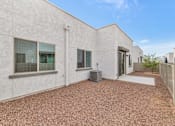 Thumbnail 49 of 81 - A white building with a brown gravel ground at Marketside Villas at Verrado, Buckeye, AZ