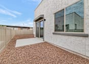 Thumbnail 48 of 81 - A modern house with a glass door and a gravel driveway at Marketside Villas at Verrado, Buckeye, AZ