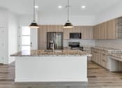 Thumbnail 55 of 81 - A modern kitchen with a large island in the center at Marketside Villas at Verrado, Buckeye, AZ