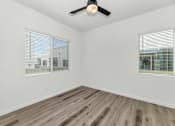 Thumbnail 58 of 81 - A room with a ceiling fan and wooden flooring at Marketside Villas at Verrado, Buckeye, AZ