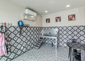 Thumbnail 69 of 81 - A room with a patterned wallpaper and a table with chairs at Marketside Villas at Verrado, Buckeye, AZ