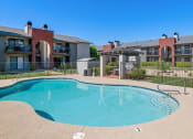 Thumbnail 1 of 34 - A swimming pool in front of apartment buildings at Reflections at Red Mountain Apartments, Mesa, Arizona