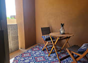 Thumbnail 12 of 14 - Private patio with outdoor dining furniture at Pinon Lofts Apartments, Sedona