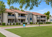 Thumbnail 6 of 20 - Apartment complex with a blue sign in front.