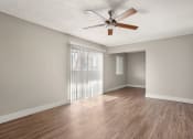 Thumbnail 9 of 48 - an empty living room with a ceiling fan at Denim Scottsdale, Scottsdale, AZ