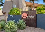 Thumbnail 48 of 48 - a sign in front of a building with palm trees in the background