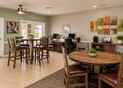 Thumbnail 20 of 20 - A dining room with a table surrounded by chairs.