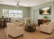 Thumbnail 19 of 20 - A living room with a ceiling fan and a large window.