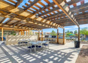 Thumbnail 36 of 48 - a patio with tables and chairs and a pergola at Denim Scottsdale, Scottsdale