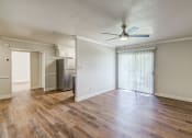 Thumbnail 8 of 48 - an empty living room with wood flooring and a ceiling fan at Denim Scottsdale, Scottsdale, AZ